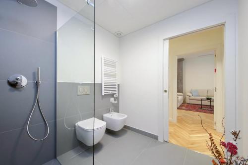 a bathroom with a toilet and a glass shower stall at CAV Juvarra in Turin