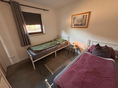 a bedroom with two beds and a window at Panoramablick am Herzoghof in Obing