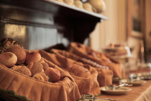 a bunch of breads in a basket on a counter at Hotel Villa Liana in Florence