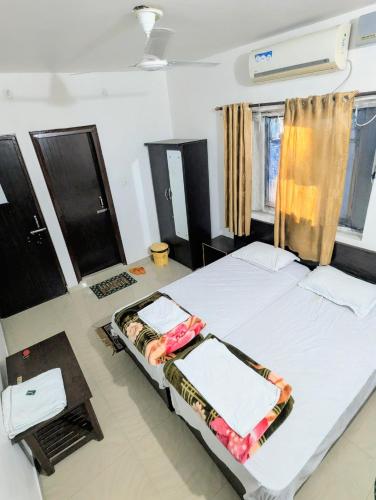 a bedroom with a large white bed in a room at Dwarka Home Stay in Bodh Gaya