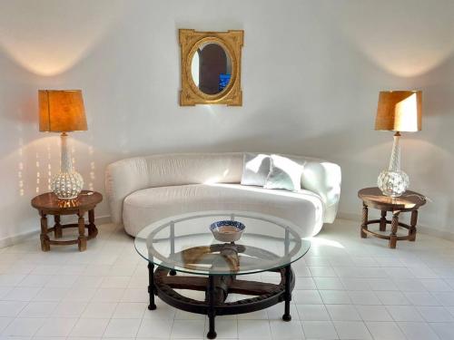 a living room with a couch and two tables at Villa Sa Torre Blanca in Colonia de Sant Pere