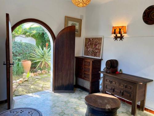 a room with a desk and a dresser and a door at Villa Sa Torre Blanca in Colonia de Sant Pere