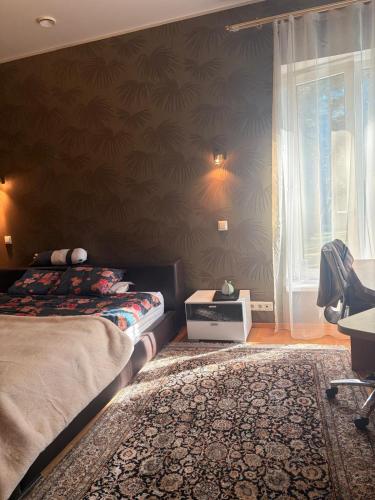 a bedroom with a bed and a window and a rug at Pirita Beach Villa in Tallinn