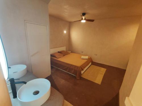 a small bathroom with a bed and a sink at local diamond in Guía de Isora