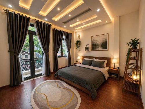 a bedroom with a bed and a large window at Nguyên căn villa Đà Lạt in Da Lat