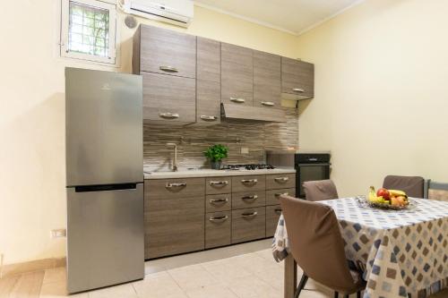 a kitchen with a stainless steel refrigerator and a table at Casa nel Borgo in Campomarino