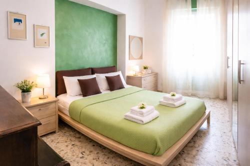 a bedroom with a large bed with towels on it at Sweet Holidays al centro di Formia in Formia