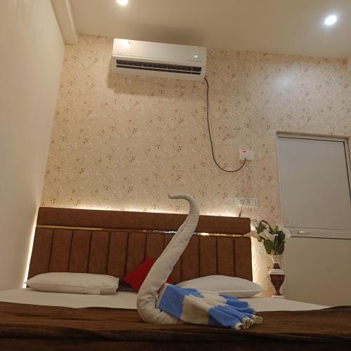 a room with a bed with a air conditioner on the wall at Hotel Kalzug in Katihār