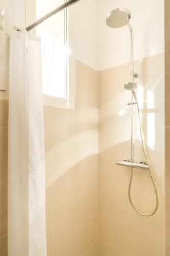 a shower in a bathroom with a shower curtain at Boutique hôtel Château Rouher in Propriano