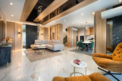 a living room with a couch and a table at Park & Spa Hotel Markovo in Plovdiv
