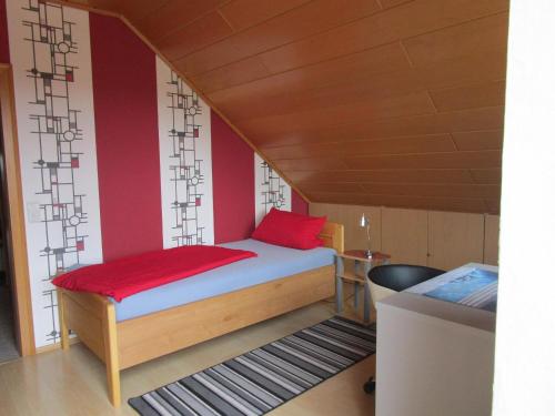 a small bedroom with a bed and a desk at Ferienwohnung Traudel in Hatzenbühl