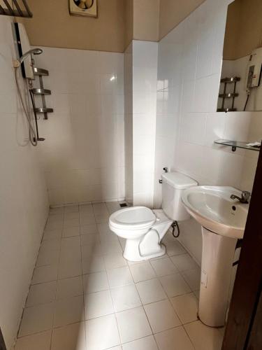 a bathroom with a toilet and a sink at Camellia Hotel in Vang Vieng