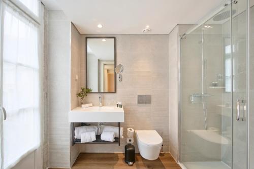 a bathroom with a sink and a shower at Hotel Moon & Sun Lisboa in Lisbon