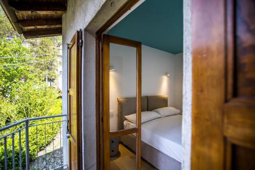 a bedroom with a bed on a balcony at La Ca di Nosee in Nesso