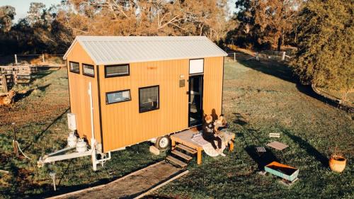 an aerial view of a tiny house in a field at Odyssean Tiny House A by Tiny Away in Cessnock