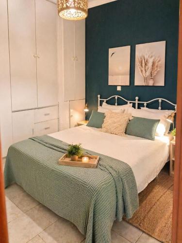 a bedroom with a bed with a green wall at Seaside Green Villa in Karianí