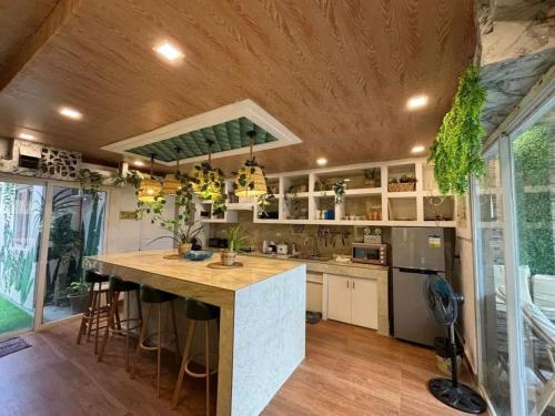 a kitchen with a large island in a house at Charming House with Private Pool in Bacolod