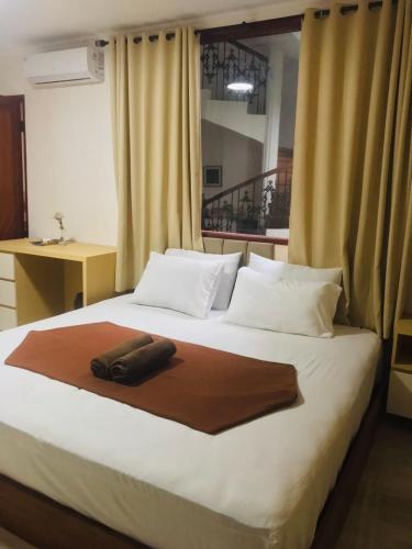 a bed with a brown blanket on top of it at The Cibulan Residence in Jakarta