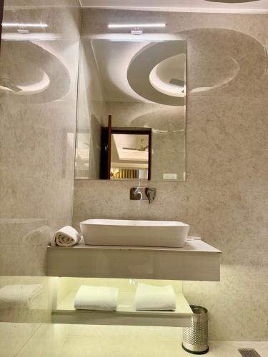 a bathroom with a sink and a mirror at The Arte in Rohtak