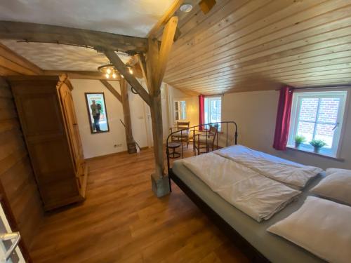 a bedroom with a bed and a wooden ceiling at Den Doezel in Vorden