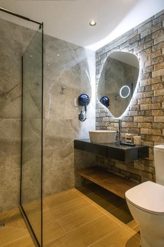 a bathroom with a sink and a mirror at Black Rocks Family Beach Resort in Agios Gordios