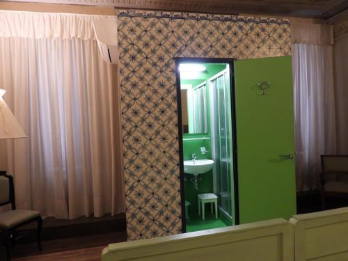 a bathroom with a sink and a mirror at La Patirana Guesthouse in Zandobbio