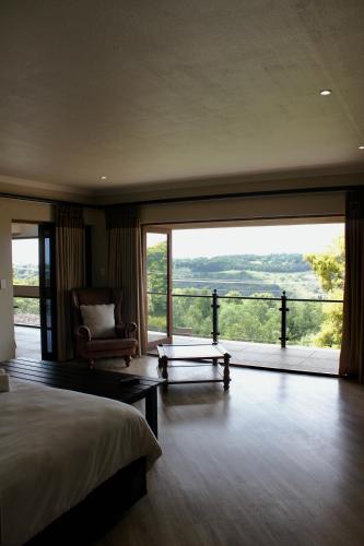 a bedroom with a bed and a large glass window at inn on mars in Pretoria