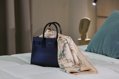 a blue bag sitting on top of a bed at Best Western Plus The Met Tirana Hotel in Tirana