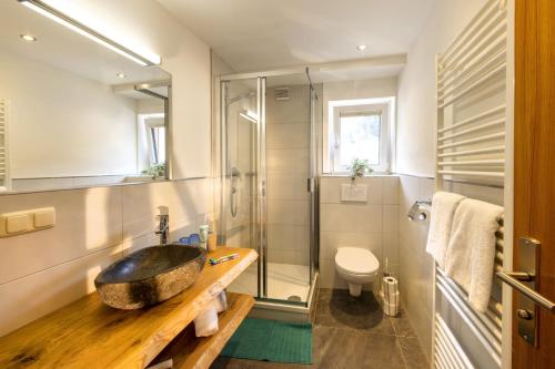 a bathroom with a stone sink and a shower at Haus am Lift in Kleinarl