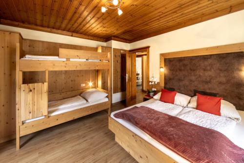 a bedroom with a bed and two bunk beds at Haus am Lift in Kleinarl