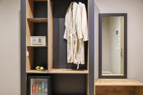 a walk in closet with a mirror in a room at Best Western Plus The Met Tirana Hotel in Tirana