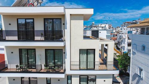 a building with chairs on a balcony in a city at Hotel Parid in Ksamil