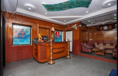 a room with wooden walls and a desk and a couch at JPResidency in Pondicherry