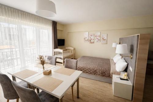 a living room with a bed and a dining room table at Five Seasons apartments in Odesa