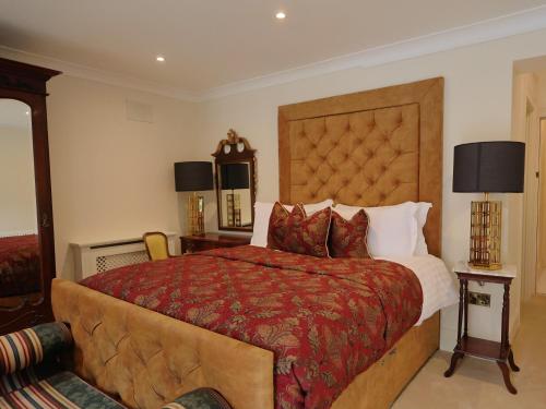 a bedroom with a large bed and two lamps at Ballagh House in Navan