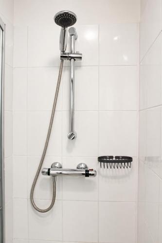 a shower with a shower head in a bathroom at Royal Seabank Hotel in Blackpool