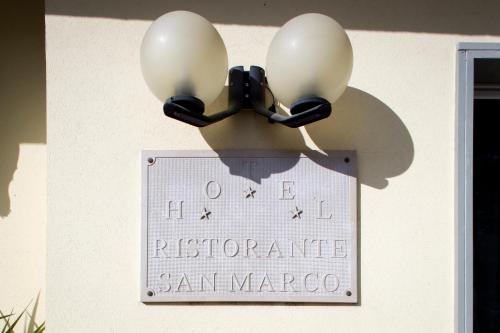 a sign for the restaurant san marco with a street light at Hotel San Marco in Rionero in Vulture