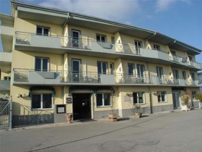 a large yellow building with balconies on a street at Hotel San Marco in Rionero in Vulture