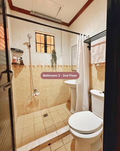 a bathroom with a shower with a toilet and a sink at Casa Clara La Union in Dalumpinas Oeste