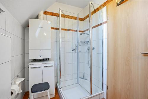 a shower in a bathroom with a glass shower stall at Möwenblick in Norddeich