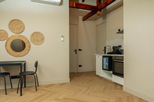 a kitchen with a table and chairs in a room at Hotel Twenty-Three Amsterdam Airport in Hoofddorp