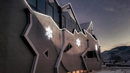 a building with lights on the side of it at Zajazd Pod Zamkiem Rytro in Rytro