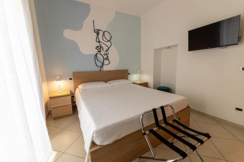 a bedroom with a bed and a flat screen tv at Il Bergamotto in Bitritto
