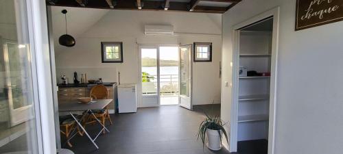 a kitchen and a dining room with a table at APPARTEMENT SANS SOUCIS in Le Vauclin