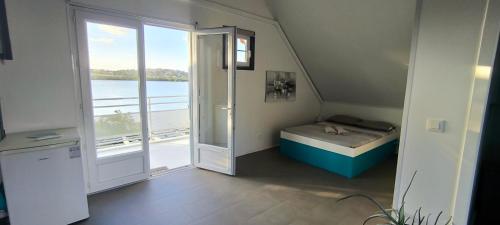 a small room with a bed and a large window at APPARTEMENT SANS SOUCIS in Le Vauclin