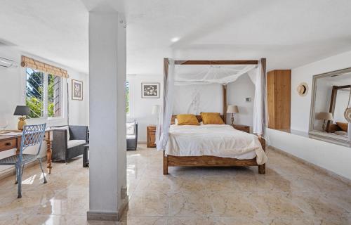 a bedroom with a bed and a desk and a chair at Casa Simba B&B in Estepona