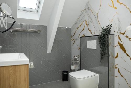 a bathroom with a toilet and a sink at Hotel Twenty-Three Amsterdam Airport in Hoofddorp