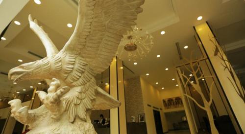 a white statue of an eagle in a building at GHS Hotel in Brazzaville