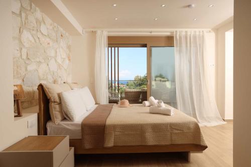 a bedroom with a bed and a large window at Aquaris in Hanioti
