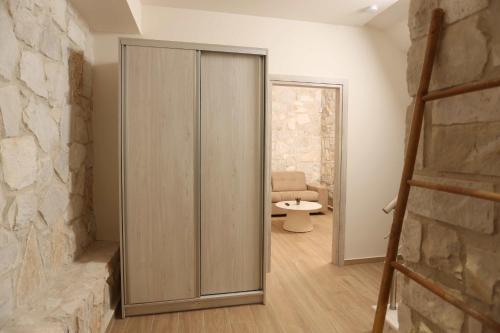 a sliding door in a room with a couch at Aquaris in Hanioti